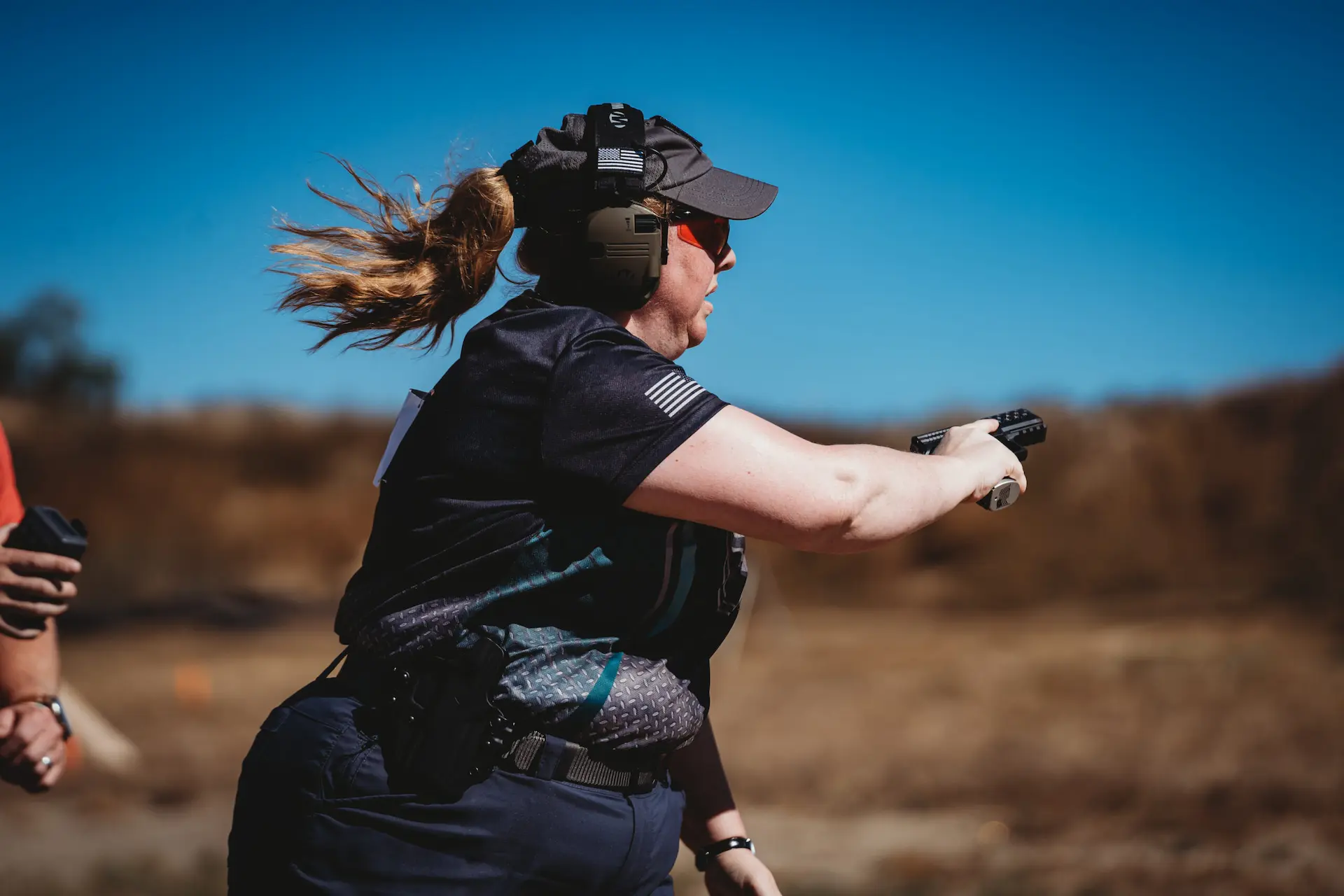 COMMUNITY PARTNERS a person shooting a pistol